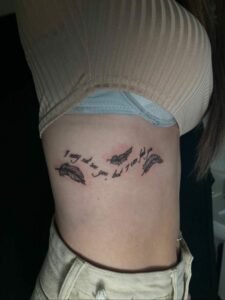 Female Tattoo Artist below breast